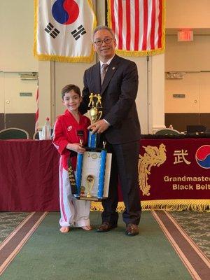 Grand Master Park presenting our son with his first degree black belt, certificate and trophy. (05/19)