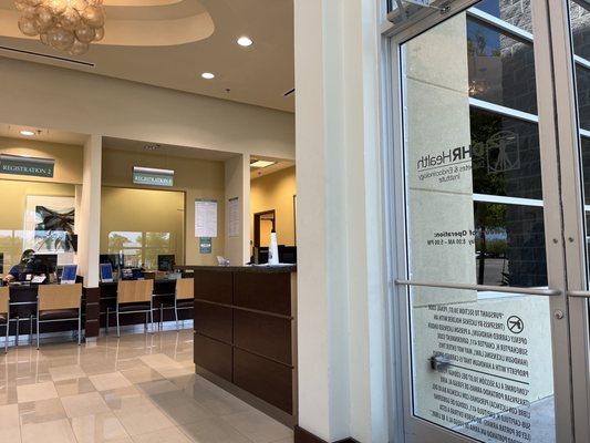 Reception desk with hand sanitizer, talk to this receptionist first.