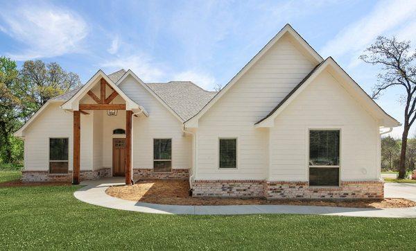 Charming white farm house new construction custom home design by Doug Parr Homes in Boyd, TX