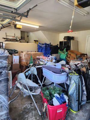 BEFORE - The garage was full. We sorted & created a keep, donate, and discard piles. We organized the items the client was keeping.