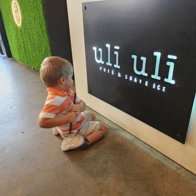 Jameson admires the Uli Uli sign!