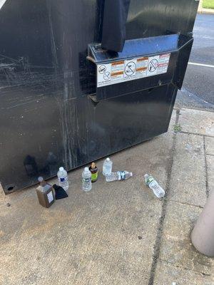 Trash beside dumpster