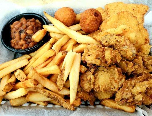 Seafood platter.  Fried oysters, shrimp, grouper, hushpuppies, baked beans, fries.