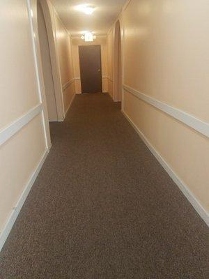 Building interior hallway carpeted.