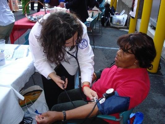 Health Fair. Our pharmacist giving free blood pressure assessments to patients.