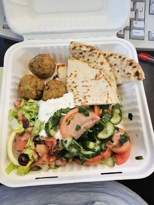 Zucchini fritter plate with cucumber tomatoes side salad.