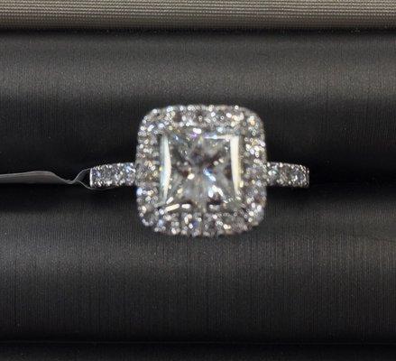 1 1/2 carat princess diamond and another 1/2 carat in smaller diamonds.