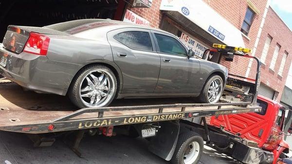 Tow Truck unloading a car for Tire Fix