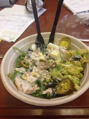 Bowl with tuna salad, hard boiled eggs, spinach, avocado, jalapeños & black olives.