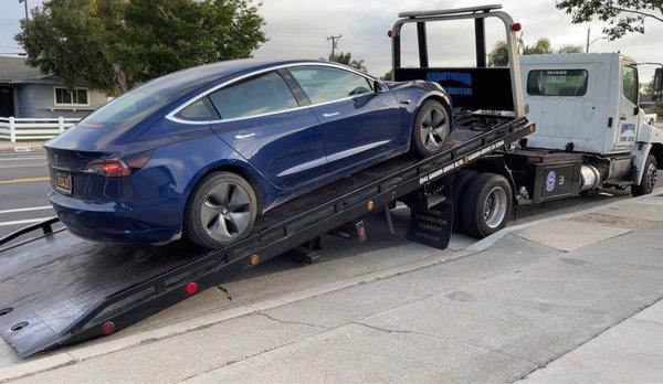 Car being loaded on flatbed