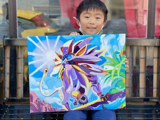 8 year old student showing his acrylic paining he made of a Pokemon character, 2021