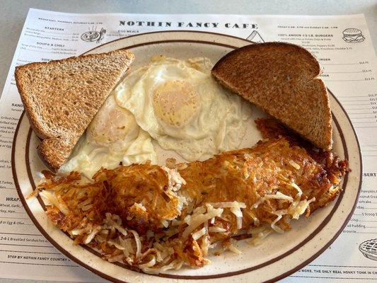 Two Eggs Over Medium with Wheat Toast and Crispy Hash Browns.