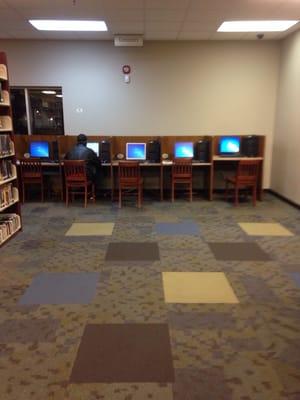 Computers to the right as you walk in at end of hall