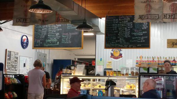 Menu board and some of the regulars at The Bagel Company