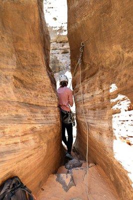 Incredible experience squeezing through this crack to repel into the slot canyon below.