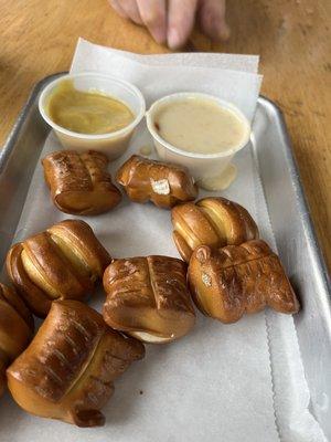 Pretzel bites with honey mustard and queso.