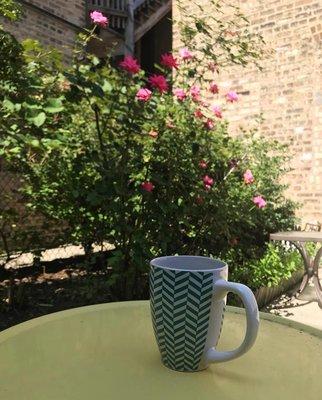 We work hard, but first coffee in the office garden.