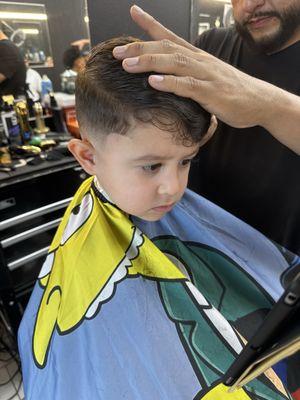 Sam the owner cutting my sons hair