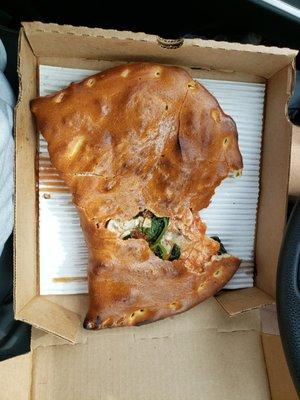 A large spinach, mushroom, chicken Pomazone (Calzone). Overall, lacking in toppings.