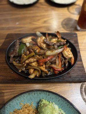 Trio fajitas with steak, chicken, and shrimp.