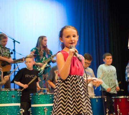 Vocal student performing on stage.