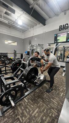 Coach Felipe and pushing his client to get stronger in his squatting