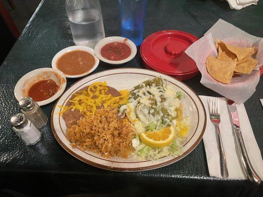 The Huevos Rancheros...mine with poached medium eggs...a container of flour tortillas, good thick chips, salsas, and water, etc.