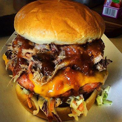 Smokin Hog Burger 1/2 Pound Hand Pressed Pork burger with Pulled Pork, cheese, coleslaw and BBQ on grilled bun..