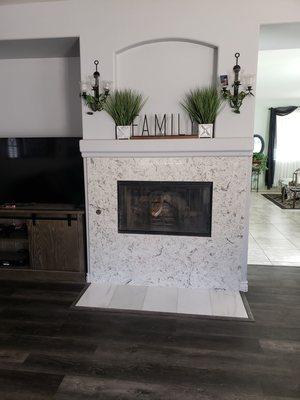 Fireplace was also redone to tie in with the kitchen counters.  Love it!