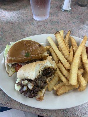 Half of a hamburger, half of a Philly cheesesteak and fries.