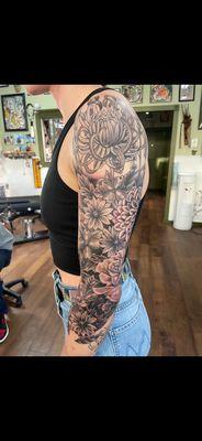 Black and grey flower sleeve tattooed done by Shawn