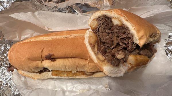 The KBBQ (Sliced Steak, Sautéed Mushrooms & Onions, Korean BBQ Sauce, Spicy Fries on Garlic Roll)