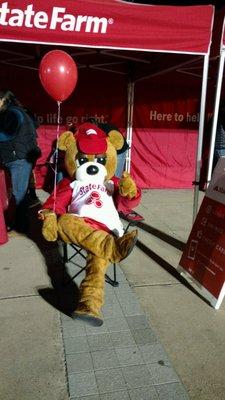 Bear is resting after getting balloons ready for parade and handing out some to joyful children.