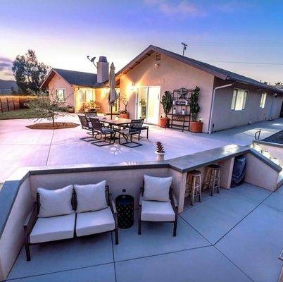 Custom bbq, concrete counter tops with wall cap and the concrete flat work