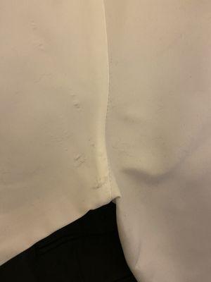 Arm pit area of a white button up dress shirt