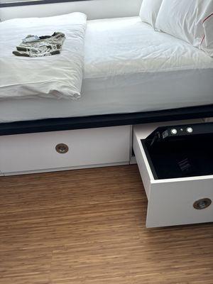 Love the under bed storage and the bed by the window.