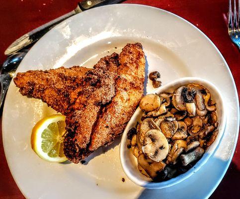 NORTH CAROLINA CATFISH. Classic flash-fried catfish with lemon caper sauce with a side of sautéed mushrooms.