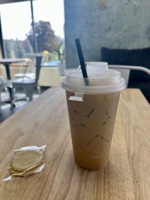 Iced vanilla latte with complimentary lemon cookies.