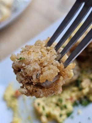 A fork with a fried oyster.