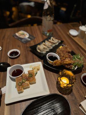 Pictured here is a cooked salmon sushi, pork gyoza and crispy chicken. everything was delicious.