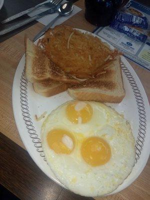 Hash browns, toast and 3 Sunnyside up eggs