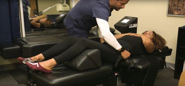 Our medical assistant strapping our patient into the spinal decompression machine.What's a spinal decompression? Check it out on our website