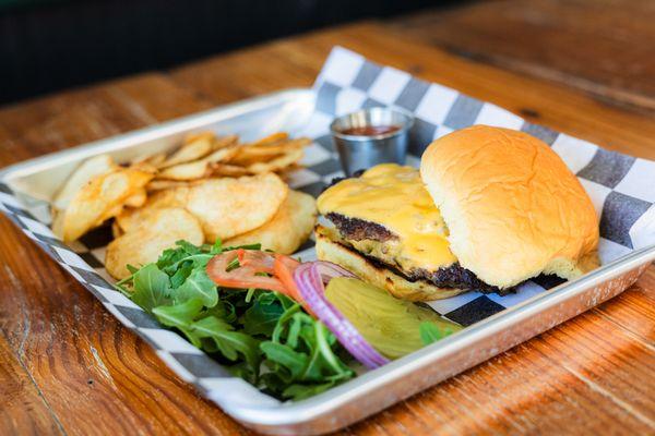 Two 1/4 lb patties smashed 'n seasoned, served w/ American cheese, toppings on the side