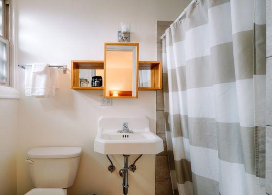 Clean, modern bathrooms with walk-in showers bring home the boutique vibe of our hotel.