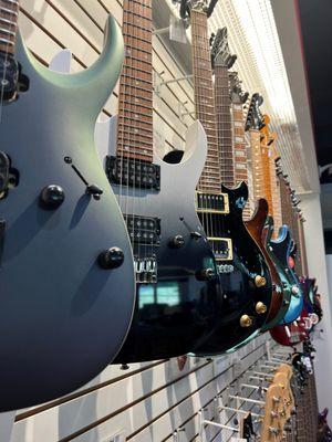 Electric Guitars hanging  in the guitar section.