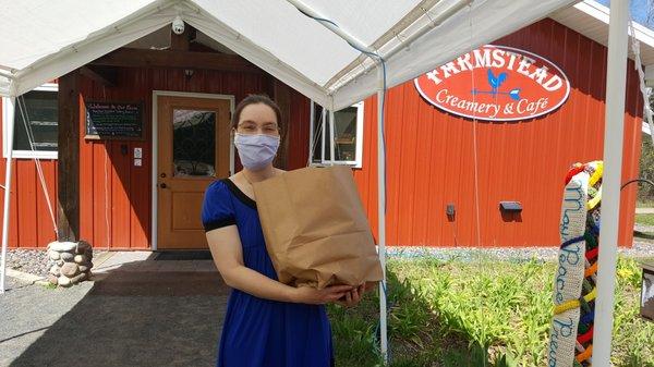 Laura bringing out delicious groceries for our "curbside" pickup.  Pre-order via our new e-store!