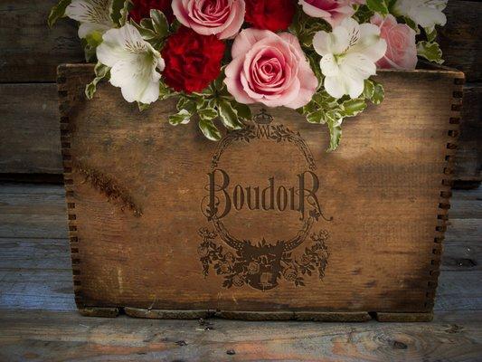 The logo for Le Boudoir in Brooklyn stamped onto a wooden box.