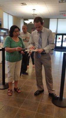 When the line at the teller's got too long...Adam came out to assist and fill in deposit slips and help the line move faster.