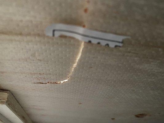 Underneath the drawer. They tried to fix it with paper. Smh!!!! Shame on them!!!