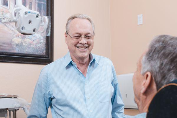 Dr Cutts consults with a patient regarding their treatment and care